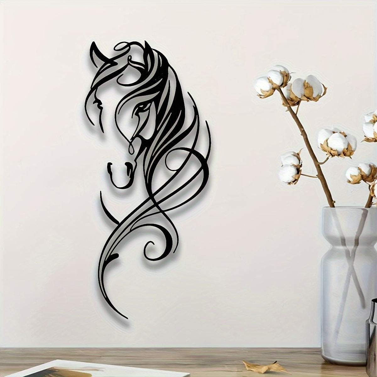 Abstract Metal Horse Wall Art Equestrian Elegance displaying elegant black swirling horse silhouette against white wall near cotton stems