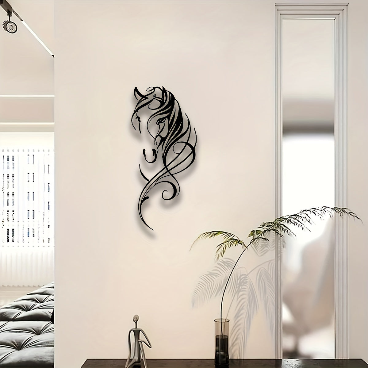 Elegant abstract metal horse wall art featuring flowing lines and artistic curves mounted on cream-colored wall