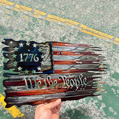 Distressed metal American flag art with 1776 and We The People text featuring torn edge design and patriotic colors